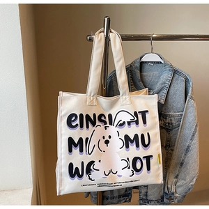 Detail of canvas tote bag featuring cute rabbit illustration and artistic lettering