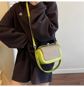 Detail of lime green crossbody bag with taupe textured fabric flap and gold clasp