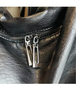 Detail of high-quality black leather texture with durable dual metal zipper sliders