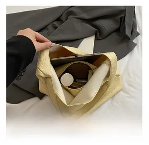 Top view of yellow pebble leather tote bag showing spacious interior and compartments