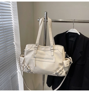 Detail of off-white motorcycle tote bag with rivet accents and soft leather texture