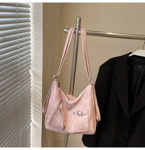 Detail view of pink vintage tote bag with metal zippers and adjustable shoulder straps