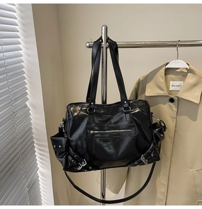 Detail of glossy pleated PU leather tote with silver rivets and multi-pocket structure