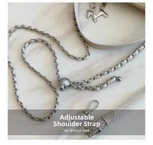Detail of white lychee leather bag with silver adjustable chain strap and pegasus charm