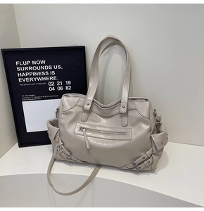 Detail of grey retro tote bag featuring glossy wrinkled leather and front zipper pocket