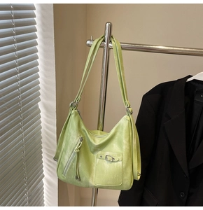 Detailed view of light green large capacity shoulder bag with washed texture and zip detail