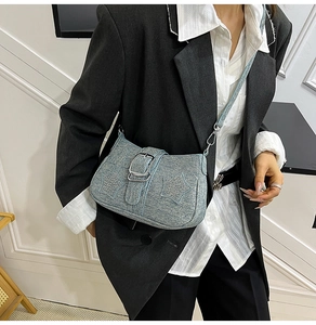 Close-up of light blue shoulder bag with star crystal ornaments and silver buckle