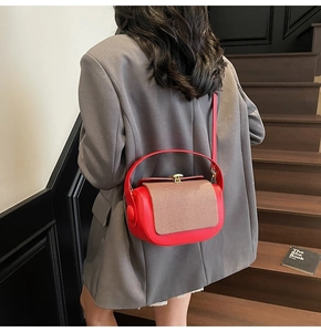 Fashionable red and brown color-block crossbody bag styled on a grey blazer outfit