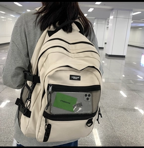 Détails d'un grand sac à dos en toile crème avec poches en filet et rangements multiples