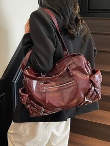 Retro burgundy large tote bag in glossy faux leather with decorative metal buckles