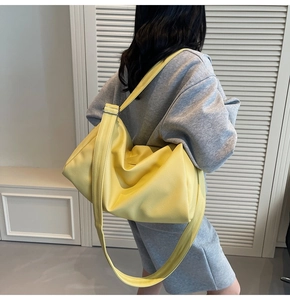 Detailed view of yellow lychee textured large hobo bag with adjustable wide shoulder strap