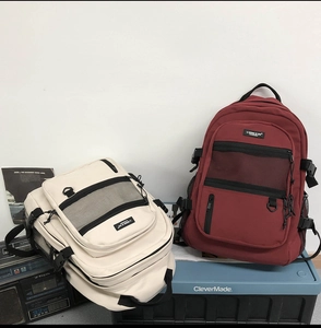 Vue avant des sacs à dos grande capacité en beige et rouge avec poches filet filet