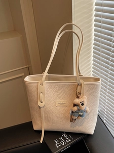 Cream large capacity leather tote bag with bear charm and pebbled texture for women