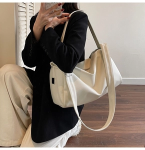 Close-up of cream large-capacity tote bag in lychee pattern leather with wide strap