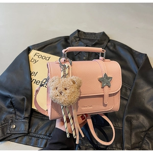 Pink faux leather crossbody bag with lychee grain texture and star-shaped metal buckle
