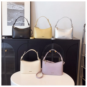 Group display of chic dumpling-style underarm bags in black yellow silver beige and purple