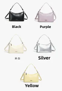 Close-up of stylish faux leather dumpling bags in five colors with metal logo and straps