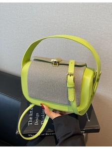 Lime green and grey textured patchwork handbag with gold buckle and top handle