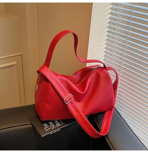 Close-up of red lychee pattern leather texture and metal zipper on the boston bag