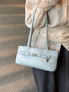 Minimalist light blue underarm bag with silver heart pendant and stylish buckle detail