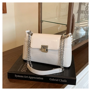 Détail du sac à bandoulière en cuir verni froissé avec chaîne et fermoir en argent