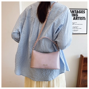 Light purple matte leather underarm bag featuring C&HEKA metal logo worn by a model
