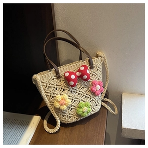 Detailed view of handmade cream crochet bag with colorful flowers and brown handles