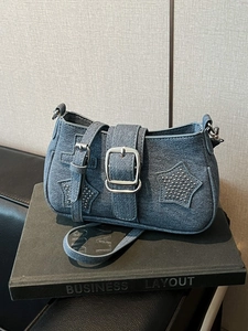 Denim shoulder bag with star rivets and silver buckle on adjustable strap