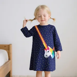 Detail of navy knit dress featuring yellow polka dots and a rainbow unicorn graphic