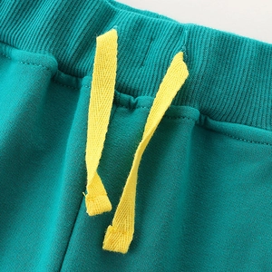 Kids' green jogger pants with elastic ribbed waistband and yellow flat drawstring detail
