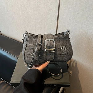 Dark grey denim shoulder bag featuring star patches and metallic punk rivet accents