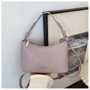 Close-up of light purple dumpling bag featuring the metal C&HEKA brand logo and texture