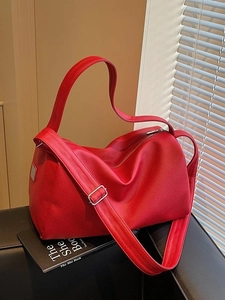 Large red pebbled leather Boston bag with wide strap and gold hardware for daily commute