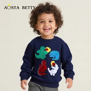 Detail of navy blue kids sweatshirt with colorful cartoon dinosaur prints and round neck