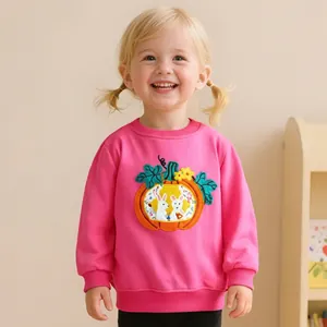 Close-up of pink girls' sweatshirt featuring pumpkin and bunny print with ribbed cuffs