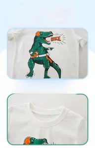 Detail shots of white cotton kids T-shirt showing ribbed neckline and green dinosaur print