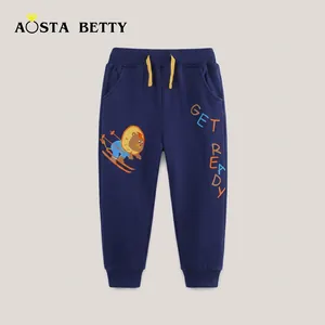 Detail of kids navy knit joggers featuring yellow drawstring and colorful lion ski print