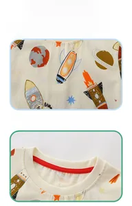 Close-up of cotton t-shirt featuring cosmic rocket prints and red ribbed crew neck detail
