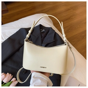Close-up of cream hobo bag with CHIC&KA metal logo and adjustable silver buckles