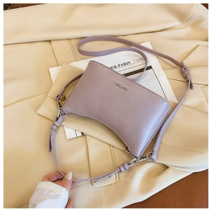 Detail of lavender hobo bag with silver C&HEKA logo and smooth faux leather texture