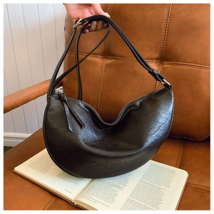Detailed view of coffee brown crescent hobo bag with vintage texture and silver hardware