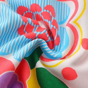 Colorful floral print on soft cotton knit fabric with vibrant cartoon patterns