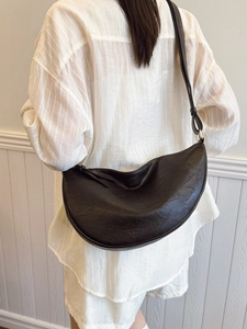 Minimalist black crescent crossbody bag with adjustable strap for casual daily use
