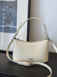 Creamy white vintage dumpling bag with metal logo and adjustable shoulder strap