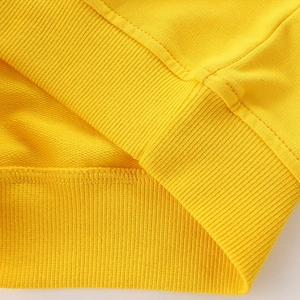 Close-up of bright yellow ribbed hem and stitching on boys' cotton sweatshirt