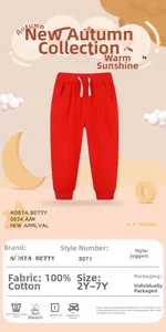 Detail of red kids joggers showing elastic waist with white drawstring and 100% cotton fabric