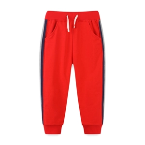 Kids red jogger pants with side stripes, elastic waist, and drawstring for sport