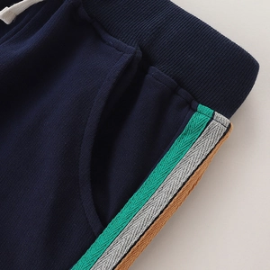 Boys' navy knit sports pants with elastic waist and tricolor striped side detail