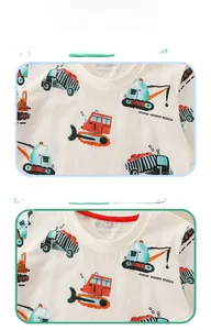 Detailed close-up of white cotton boy's t-shirt showing excavator print and red neck piping