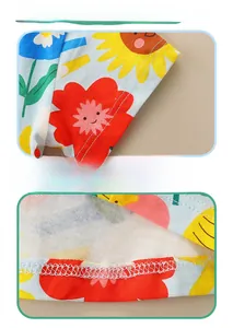 Detailed close-up of double-needle stitching on sleeves and hem of girls floral cotton dress